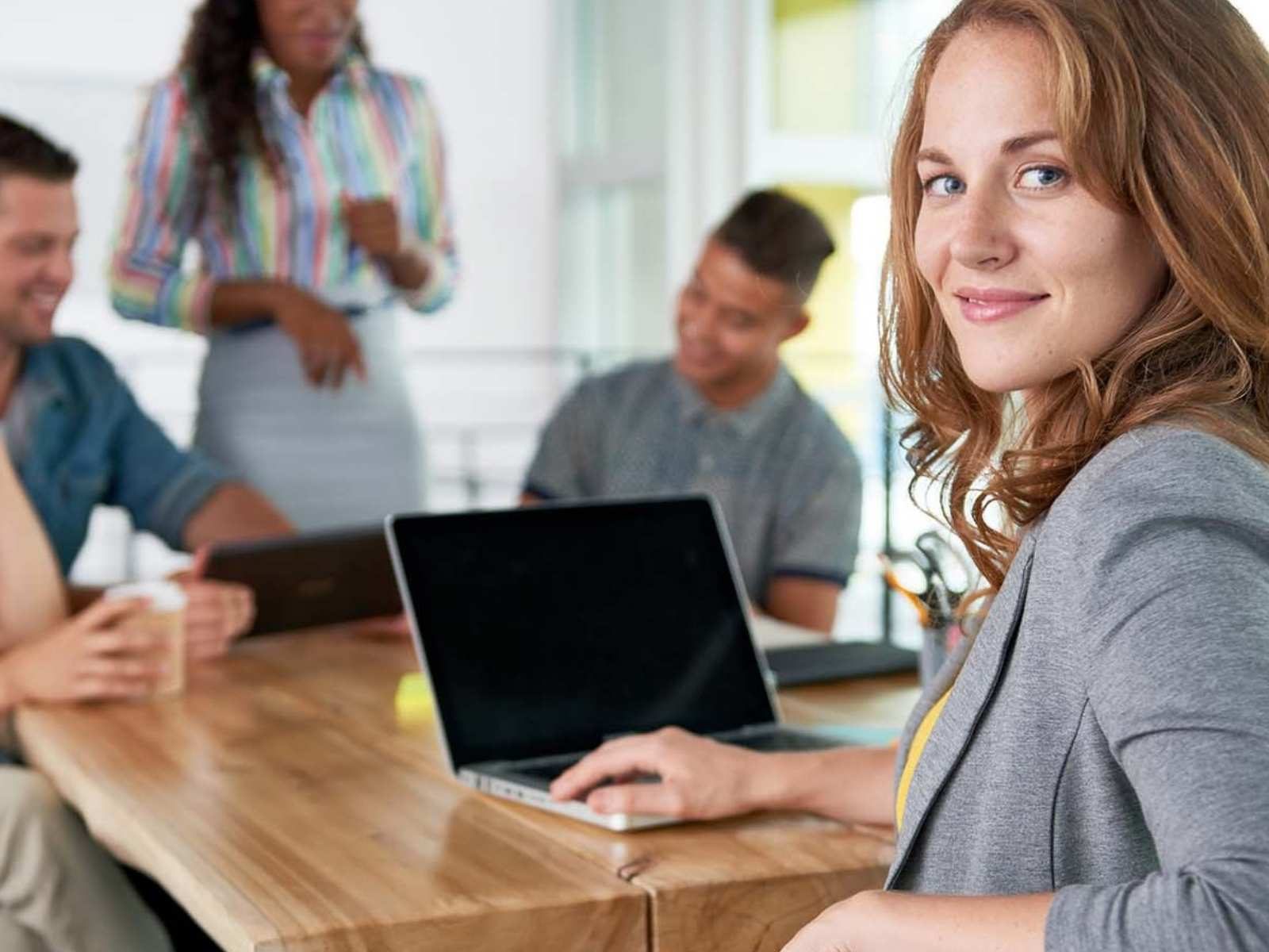 Smart woman with laptop and her e-commerce team looking back with certainty - Beating Brexit