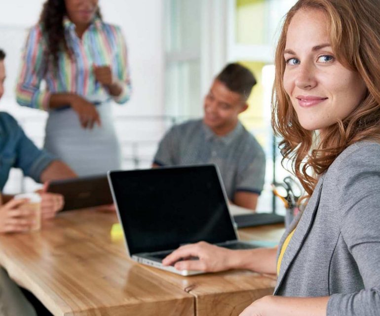 Smart woman with laptop and her e-commerce team looking back with certainty - Beating Brexit