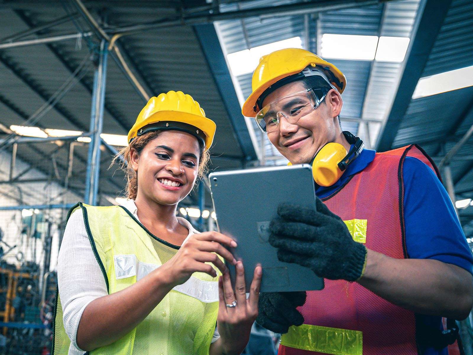 Two employees looking at a the benefits of a manufacturing e-commerce solution
