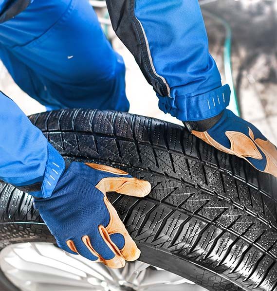 Man with tire - Univergomma's Sana Commerce web store success story