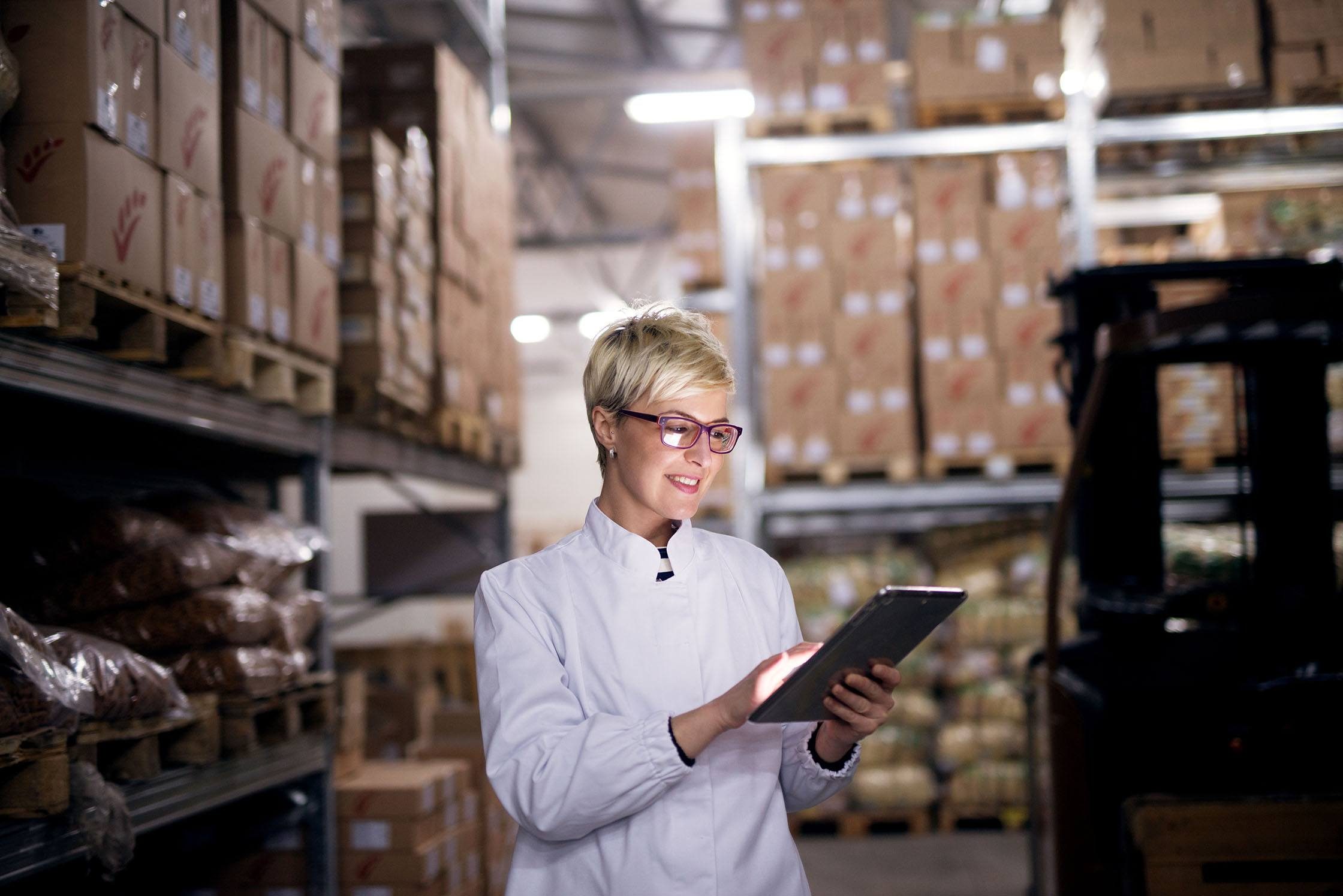 Woman who works in wine and beer distribution in her warehouse getting ready to dropship